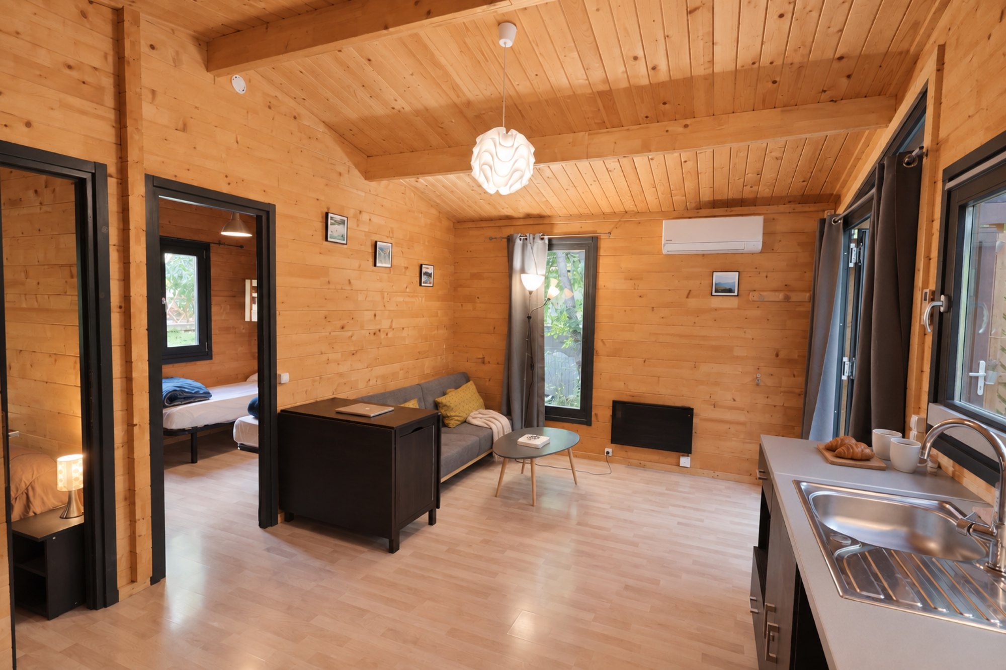 Salon du chalet en bois avec canapé et climatisation